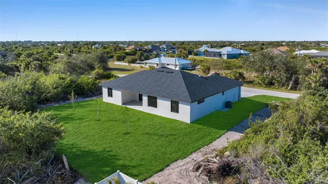 an aerial view of a house with a yard