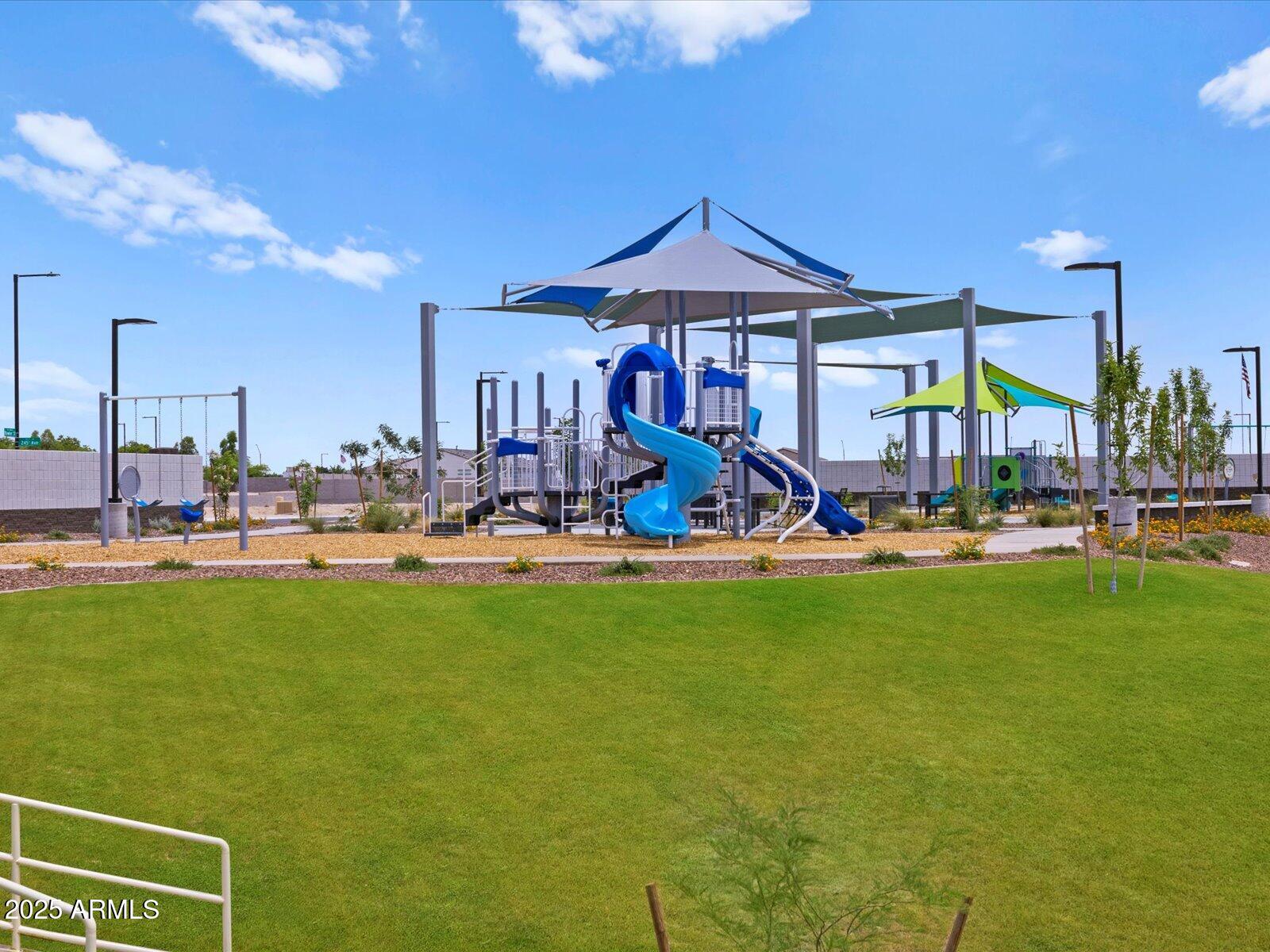 24584 West Chambers Street Buckeye, AZ 85326 - Photo 20 of 28 a group of people sitting in front of a swimming pool