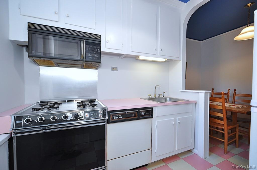 949 Palmer Road, Unit 6H Bronxville, NY 10708 - Photo 11 of 48 a kitchen with stainless steel appliances a stove and a microwave