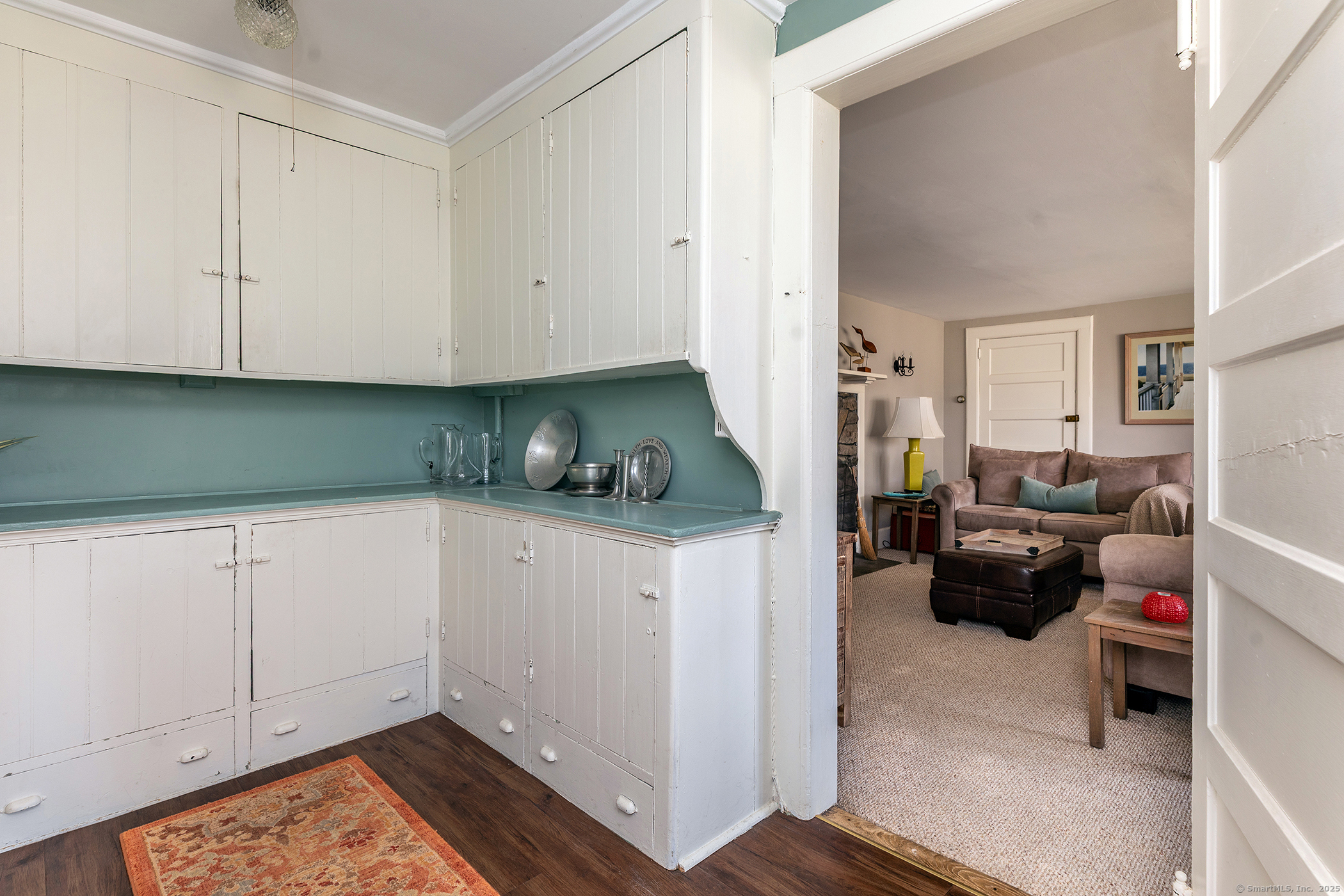 45 Sunny Ridge Road Washington, CT 06794 - Photo 8 of 15 a kitchen with white cabinets and black appliances