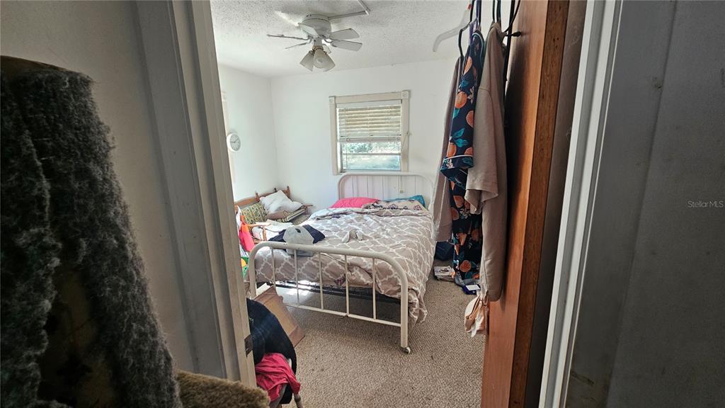 43734 West Lane Paisley, FL 32767 - Photo 11 of 38 a room that has a bed and a chair in it