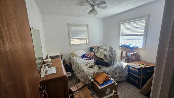 a bedroom with a bed and window