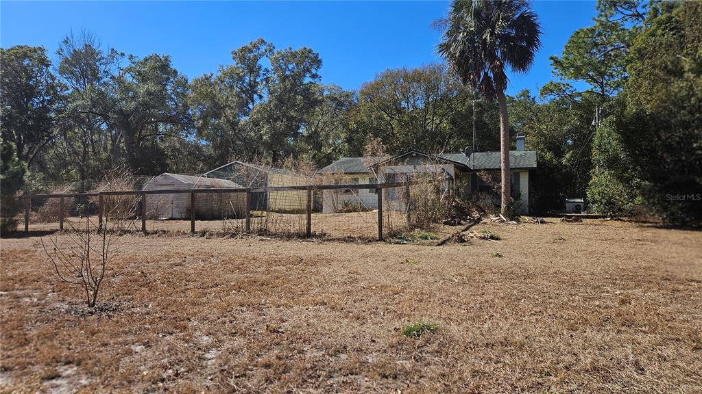 43734 West Lane Paisley, FL 32767 - Photo 19 of 38 a backyard of a house with large trees and outdoor space