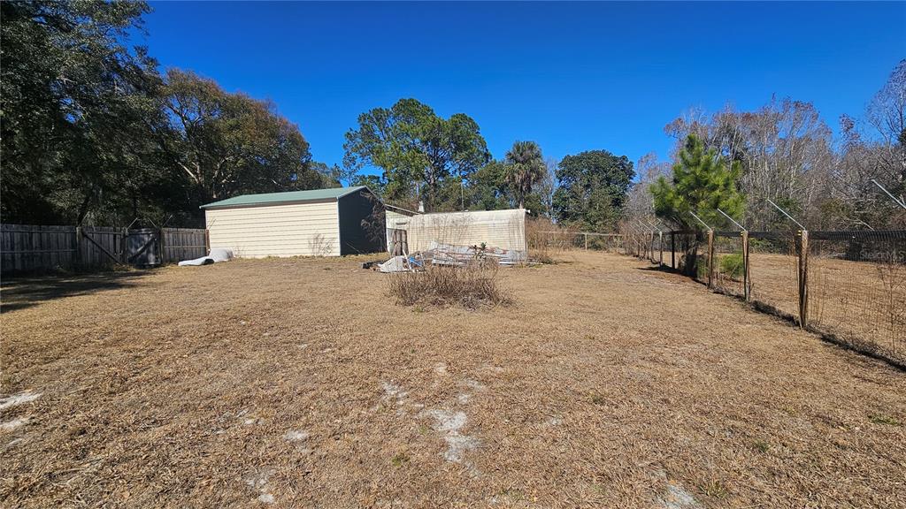 43734 West Lane Paisley, FL 32767 - Photo 30 of 38 a view of a white house with a yard and large tree