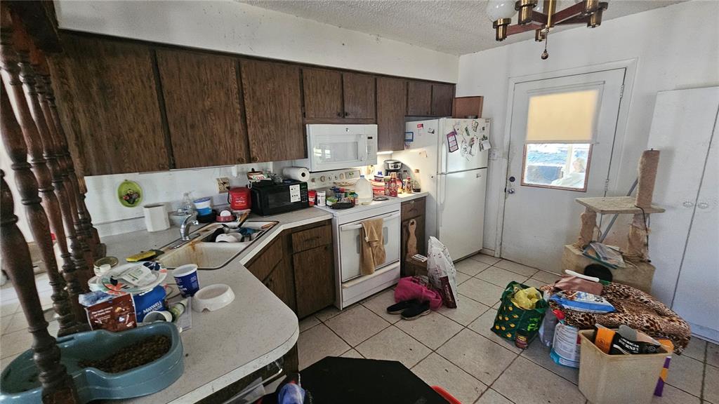 43734 West Lane Paisley, FL 32767 - Photo 7 of 38 a view of a kitchen with fridge and workspace