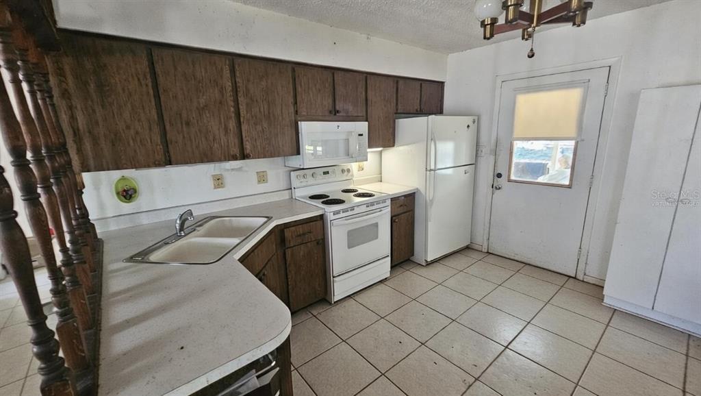 43734 West Lane Paisley, FL 32767 - Photo 8 of 38 a utility room with cabinets washer and dryer