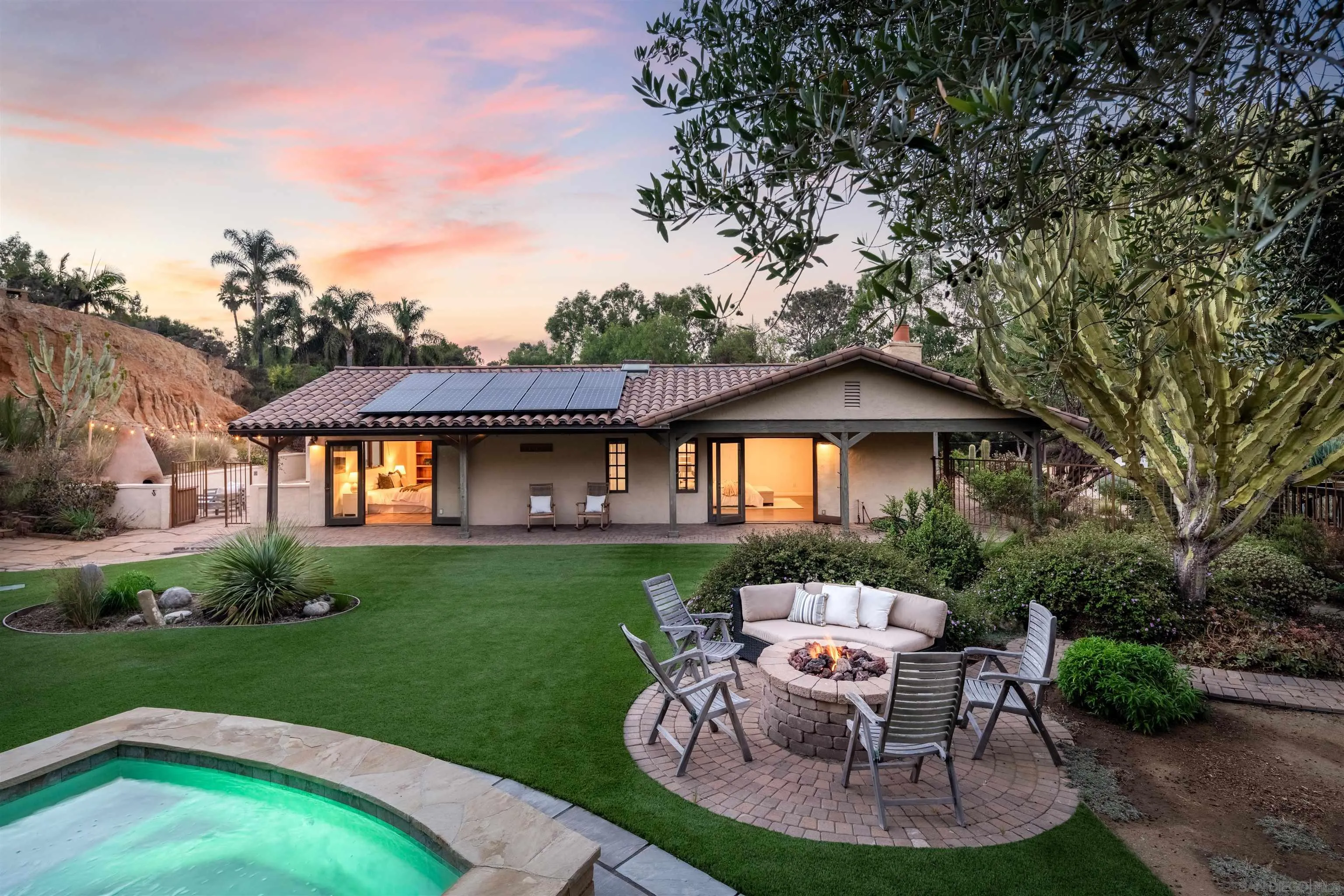 a backyard of a house with table and chairs