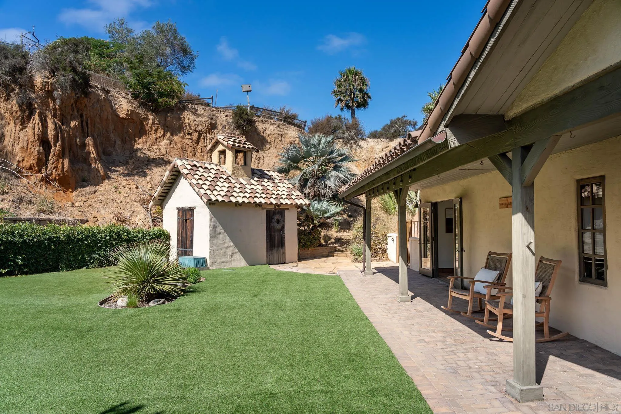 1243 Crest Drive Encinitas, CA 92024 - Photo 19 of 47 a front view of a house with a yard garden and outdoor seating