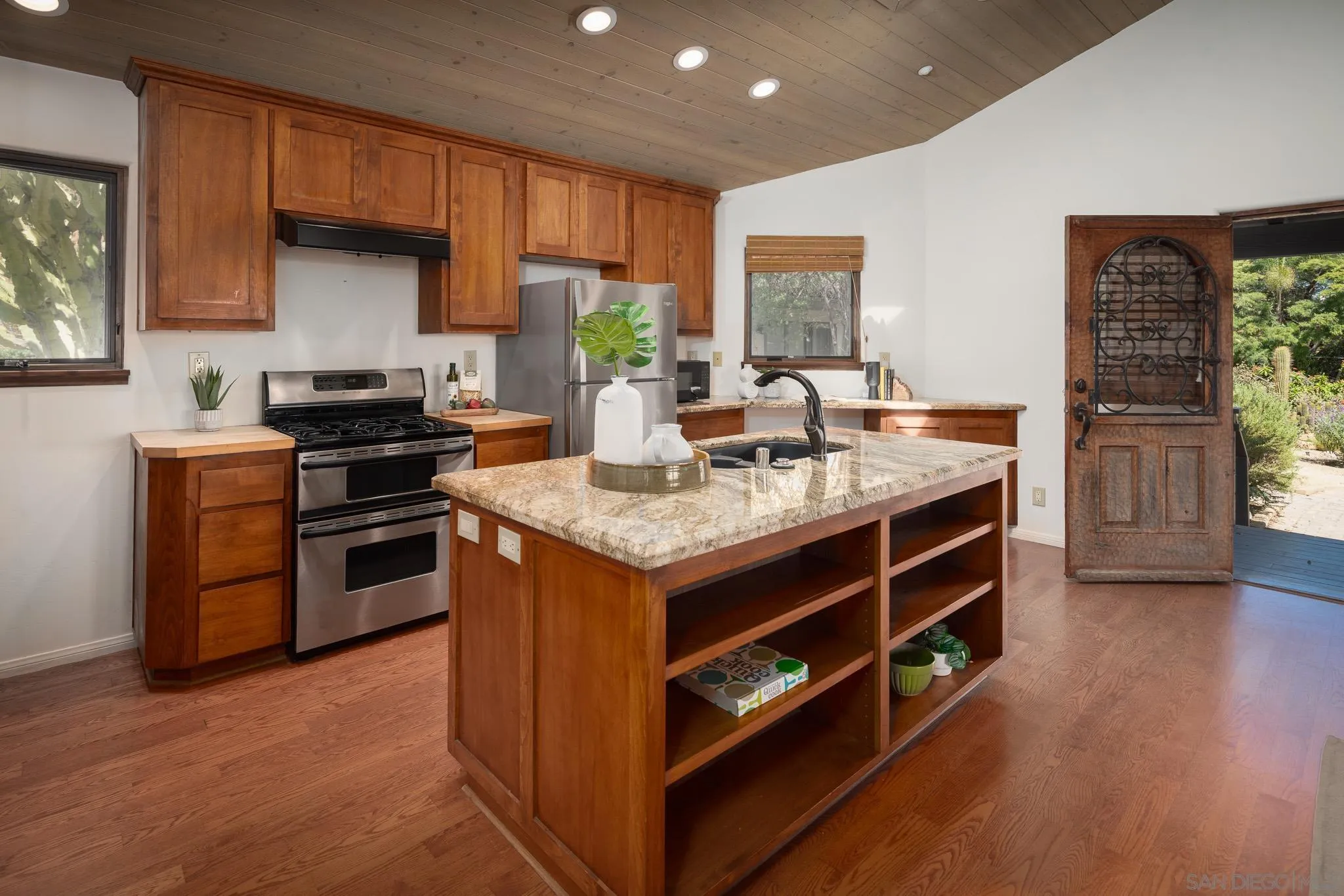 1243 Crest Drive Encinitas, CA 92024 - Photo 31 of 47 a kitchen with stainless steel appliances granite countertop a stove and a refrigerator