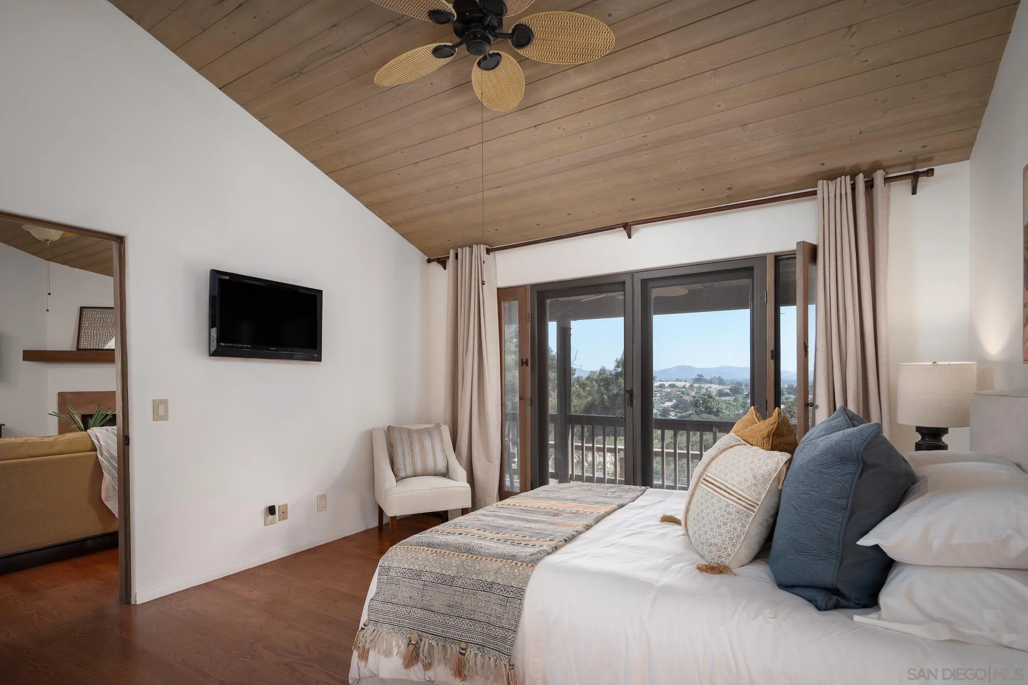 1243 Crest Drive Encinitas, CA 92024 - Photo 32 of 47 a bedroom with a bed and a flat screen tv