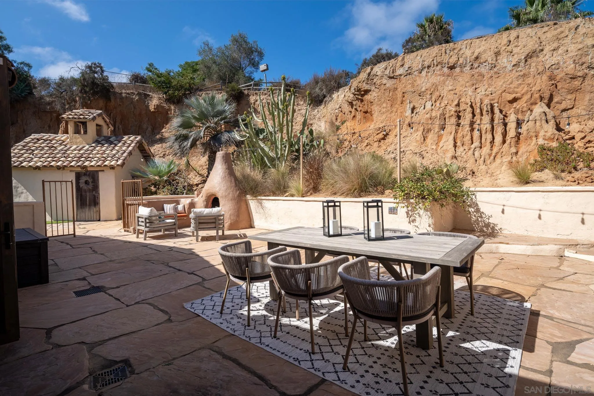 1243 Crest Drive Encinitas, CA 92024 - Photo 10 of 47 a view of a patio with table and chairs with wooden floor and fence