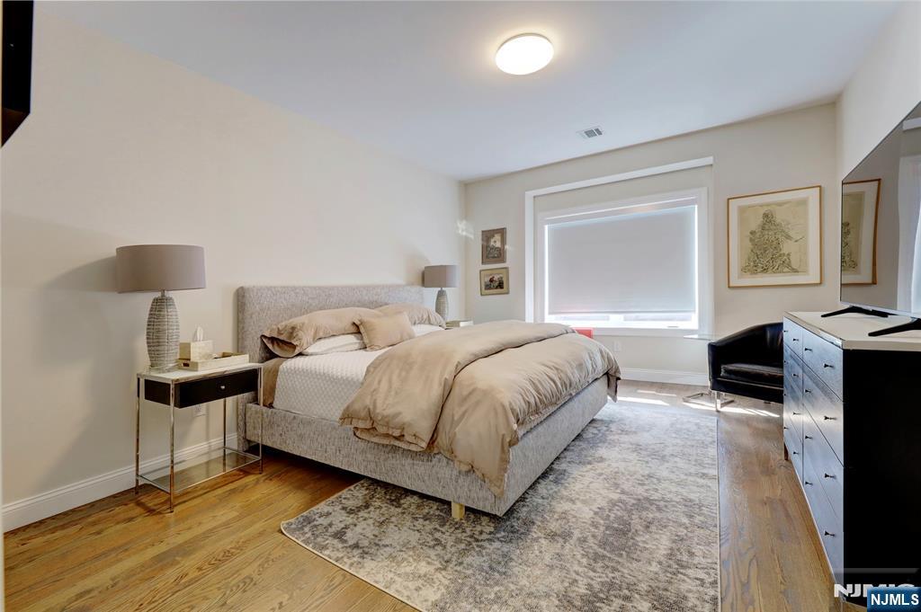 63 Sunset Lane Tenafly, NJ 07670 - Photo 14 of 20 a bedroom with a bed and a flat screen tv