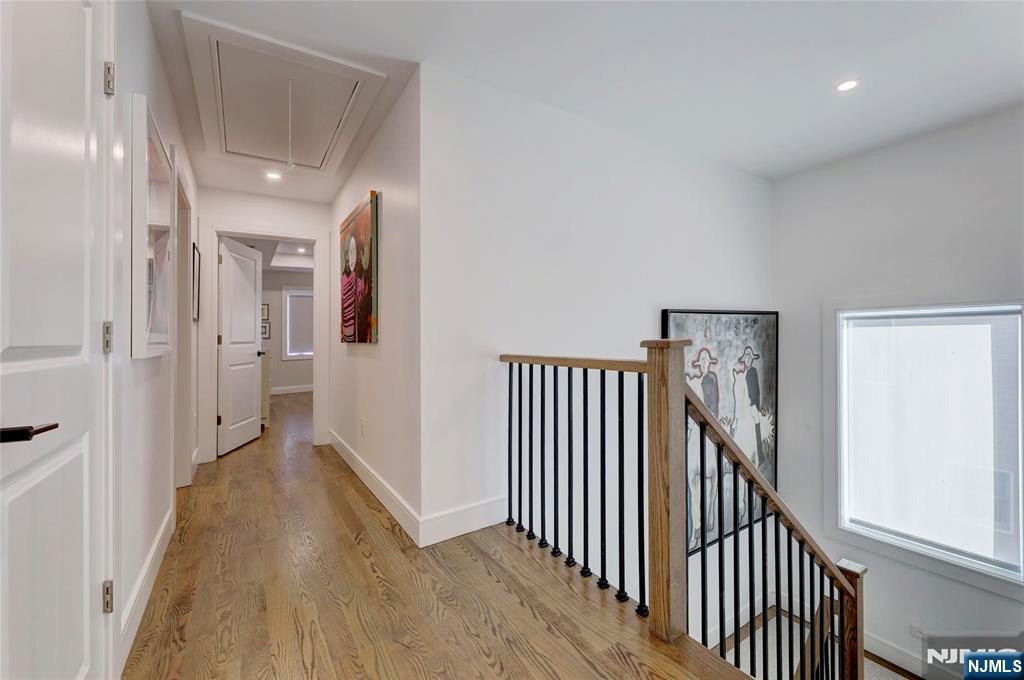 63 Sunset Lane Tenafly, NJ 07670 - Photo 15 of 20 a view of a hallway with wooden floor and stairs