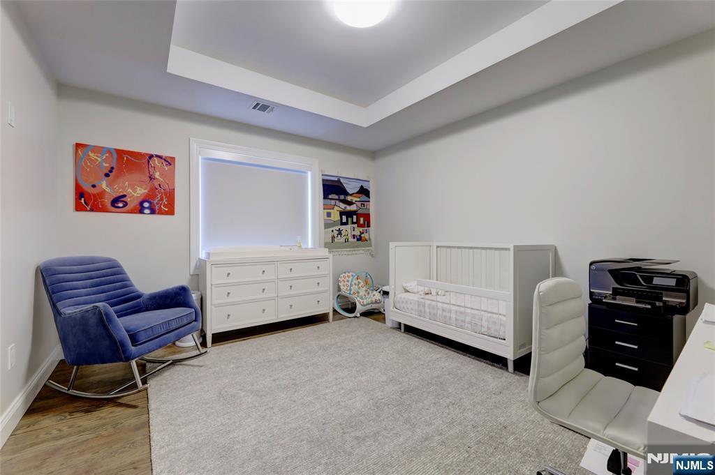 63 Sunset Lane Tenafly, NJ 07670 - Photo 16 of 20 a bedroom with furniture and a chair