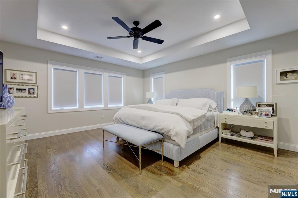 63 Sunset Lane Tenafly, NJ 07670 - Photo 18 of 20 a spacious bedroom with a bed and a large window