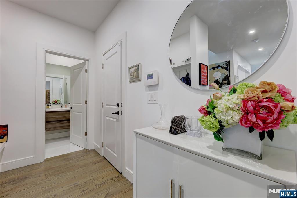 63 Sunset Lane Tenafly, NJ 07670 - Photo 6 of 20 a hallway with flowers and wooden floor
