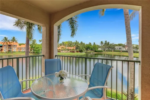 a view of a balcony with chair and wooden floor
