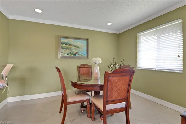 a view of a dining room with furniture and window