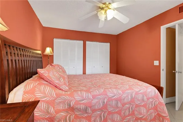 a bed sitting in a bedroom and a chandelier