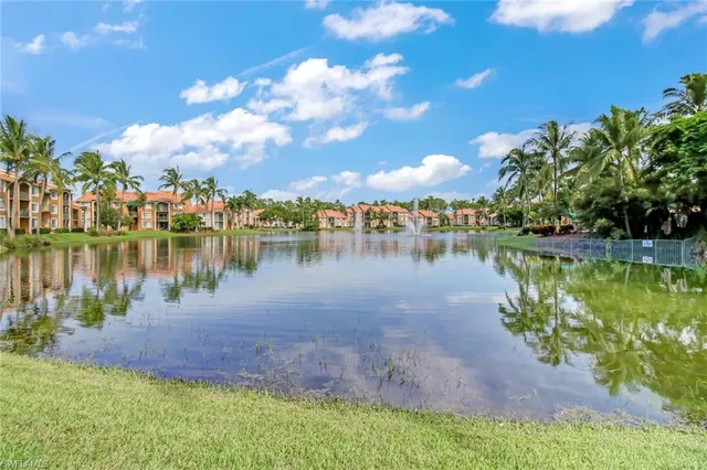 a view of a lake with houses in the back