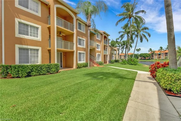 a front view of a residential apartment building with a yard