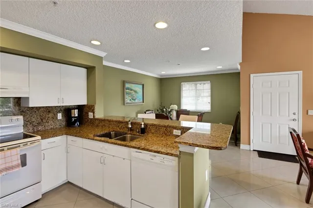 a kitchen with granite countertop sink cabinets and stainless steel appliances
