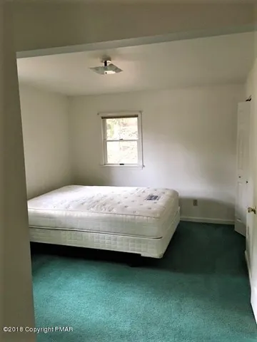 a bathroom with a bathtub and window