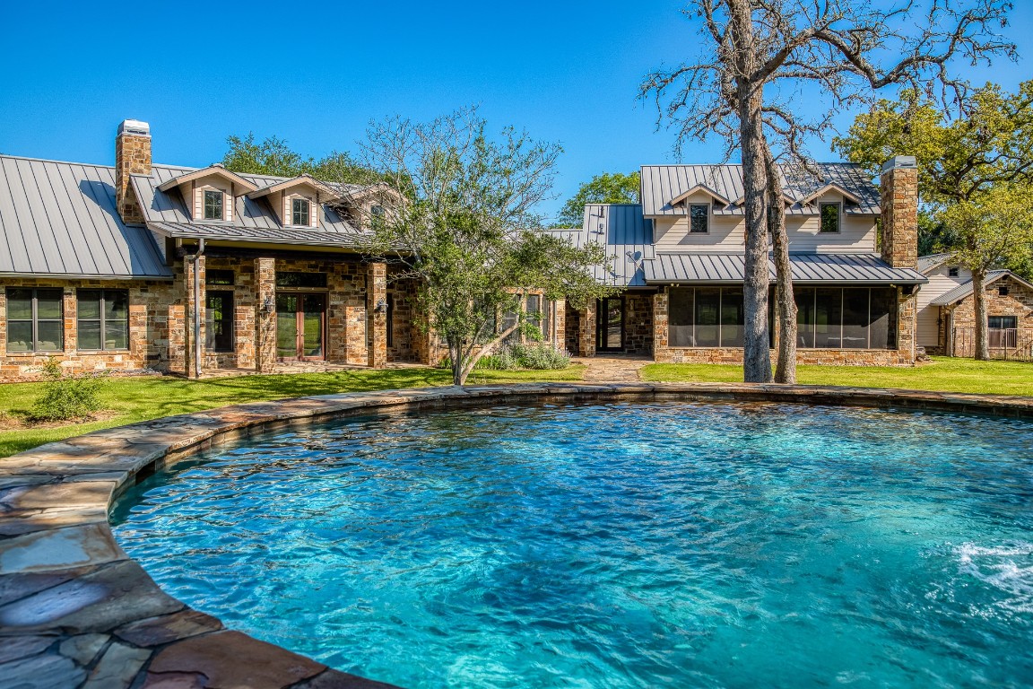 6925 South Sycamore Crossing Road Bellville, TX 77418 - Photo 27 of 40 a view of a house with a swimming pool