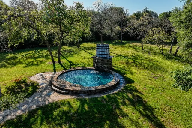a view of a backyard with swimming pool