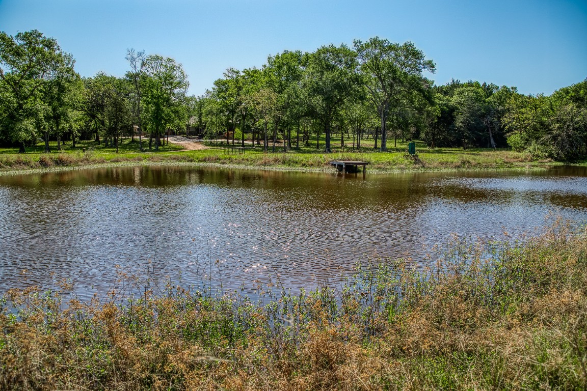 6925 South Sycamore Crossing Road Bellville, TX 77418 - Photo 33 of 40 a view of a lake with a house in background