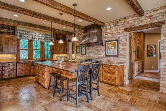 a kitchen with stainless steel appliances granite countertop a sink and cabinets