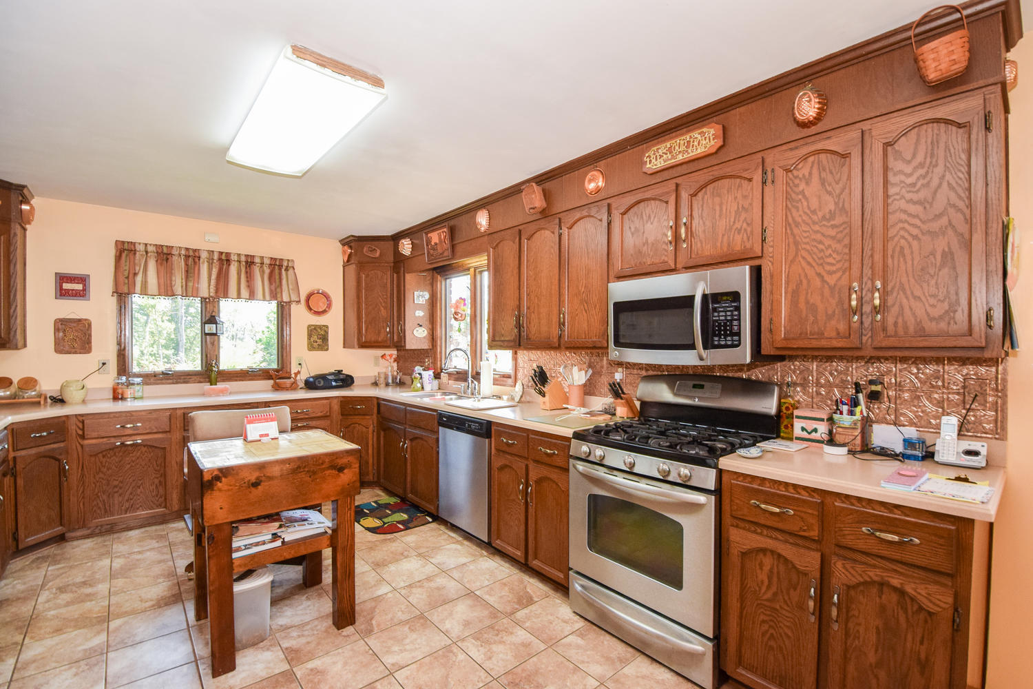 211 Rhododendron Road Callaway, VA 24067 - Photo 13 of 48 a kitchen with stainless steel appliances granite countertop a stove top oven a sink dishwasher a dining table and chairs with wooden floor