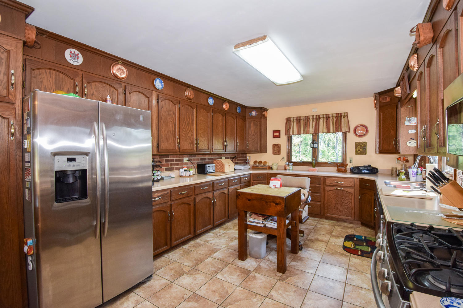 211 Rhododendron Road Callaway, VA 24067 - Photo 14 of 48 a kitchen with stainless steel appliances granite countertop a refrigerator a sink a stove and chairs