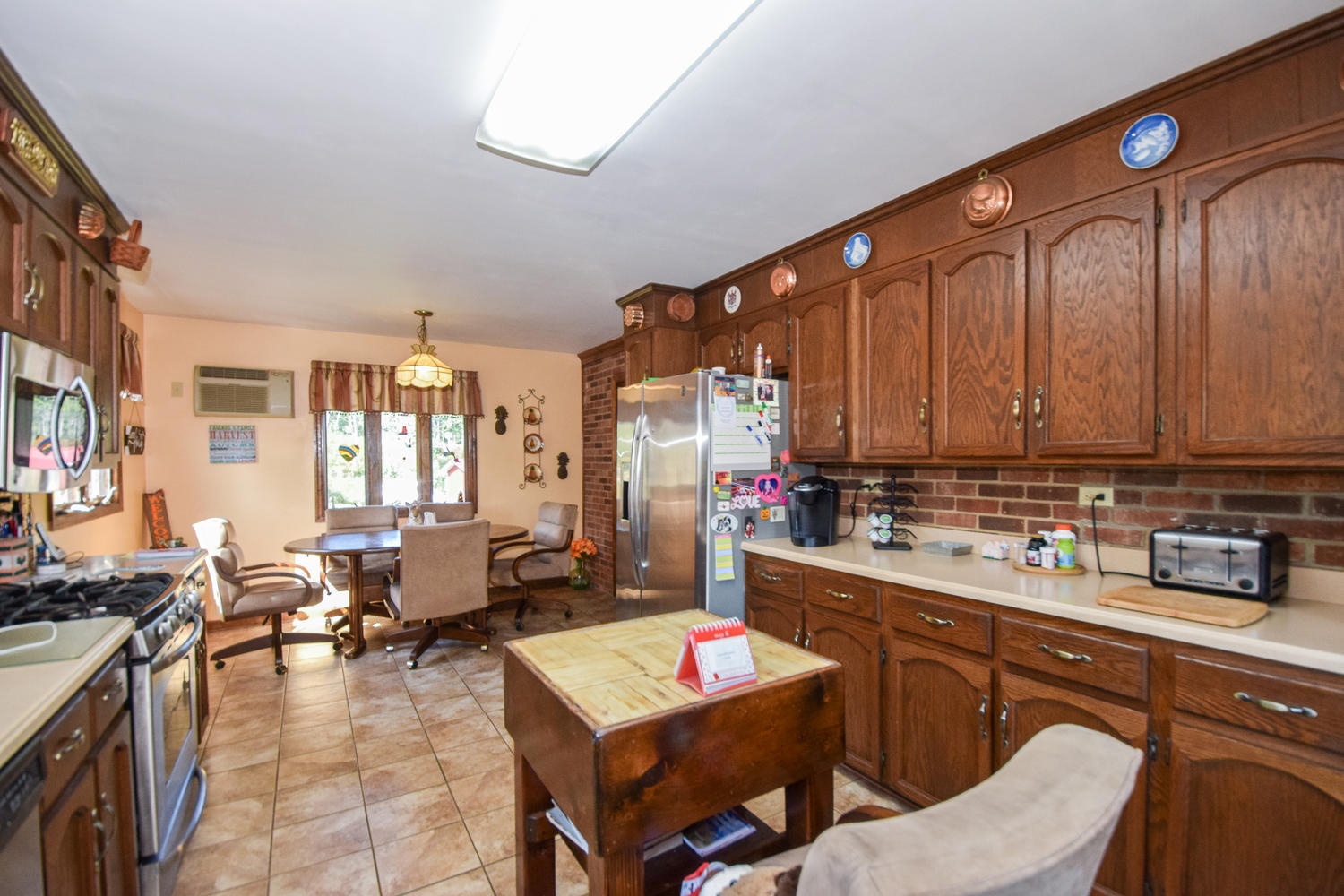 211 Rhododendron Road Callaway, VA 24067 - Photo 15 of 48 a kitchen with a sink stove and chairs