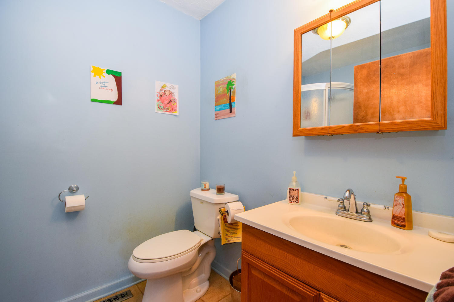 211 Rhododendron Road Callaway, VA 24067 - Photo 17 of 48 a bathroom with a toilet a sink and mirror