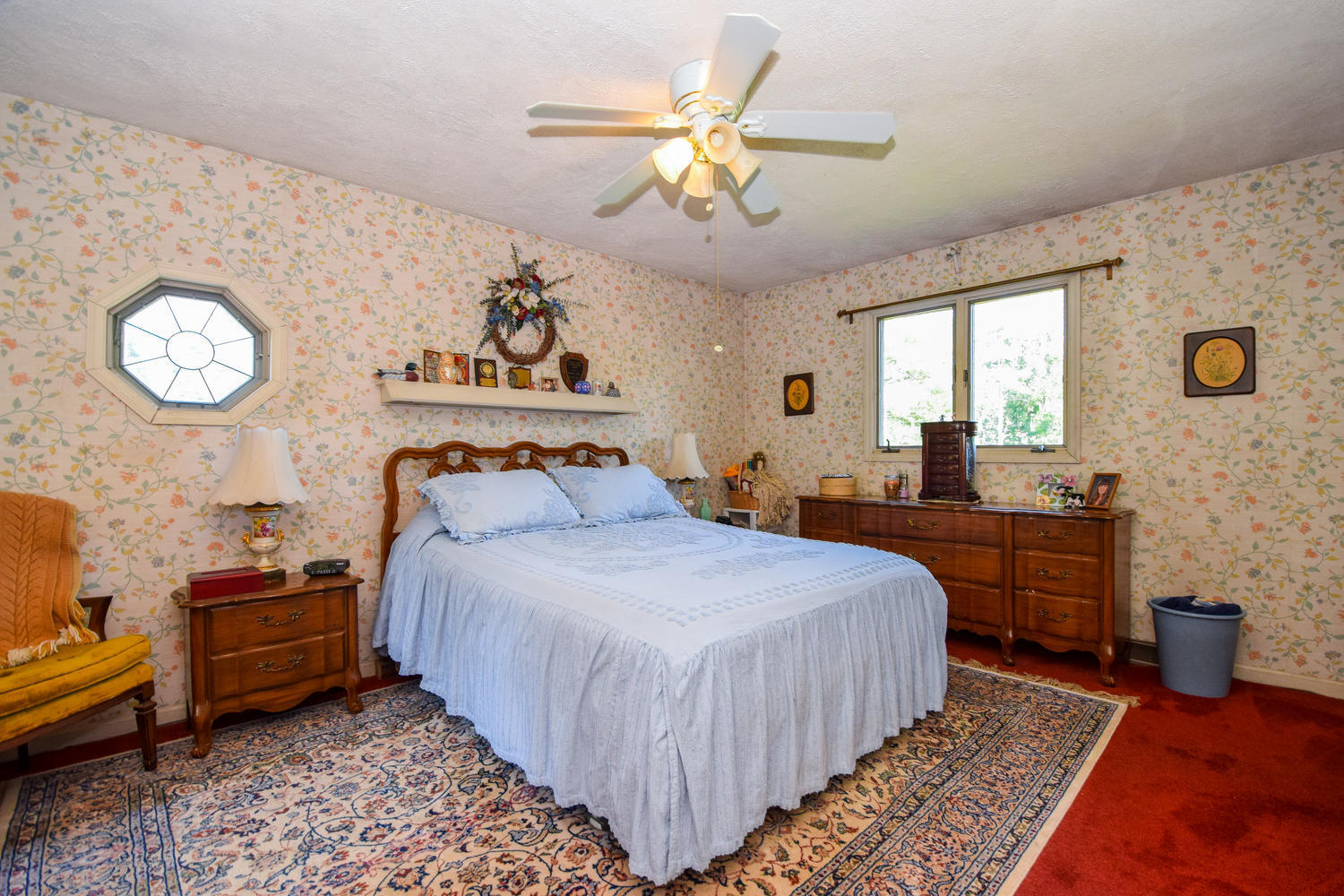 211 Rhododendron Road Callaway, VA 24067 - Photo 23 of 48 a bedroom with bed and a chandelier