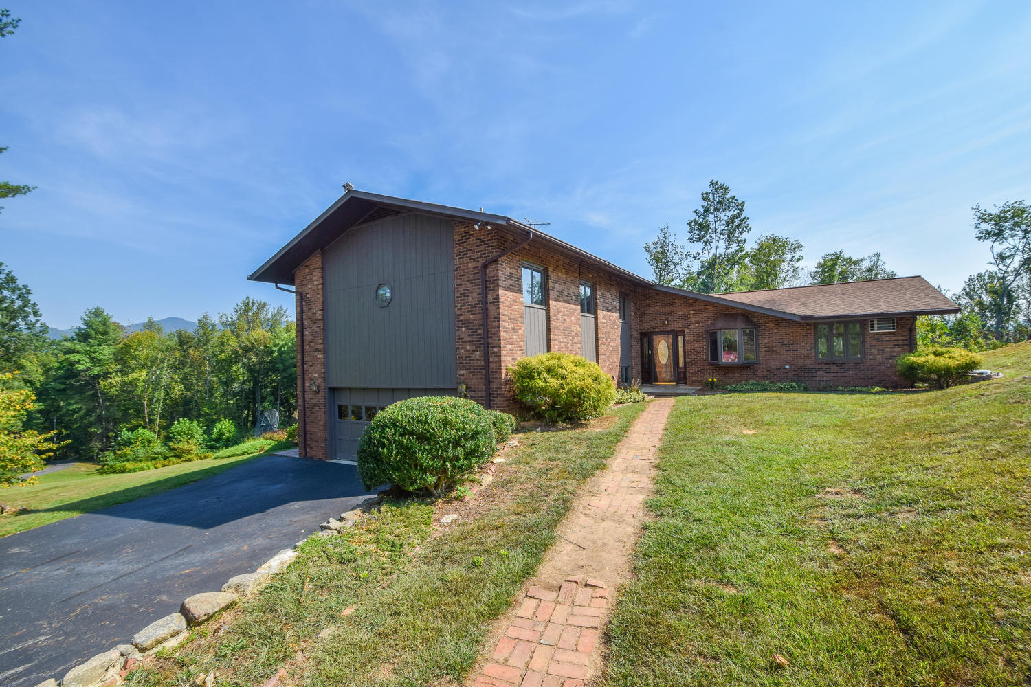 211 Rhododendron Road Callaway, VA 24067 - Photo 34 of 48 a front view of a house with a yard and garage
