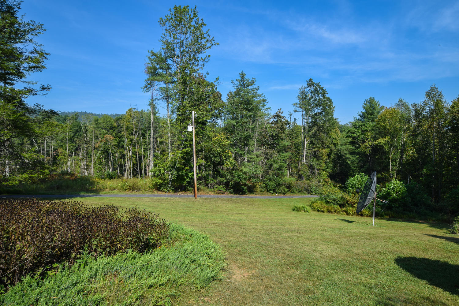211 Rhododendron Road Callaway, VA 24067 - Photo 39 of 48 a view of a grassy field with trees in the background