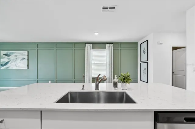 a spacious bathroom with a granite countertop sink mirror and a shower