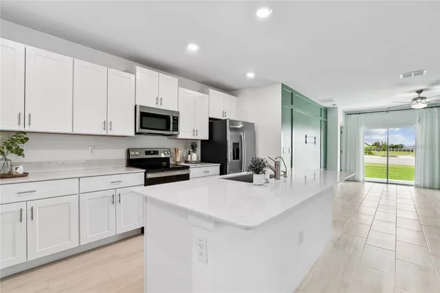 a kitchen with white cabinets and white appliances