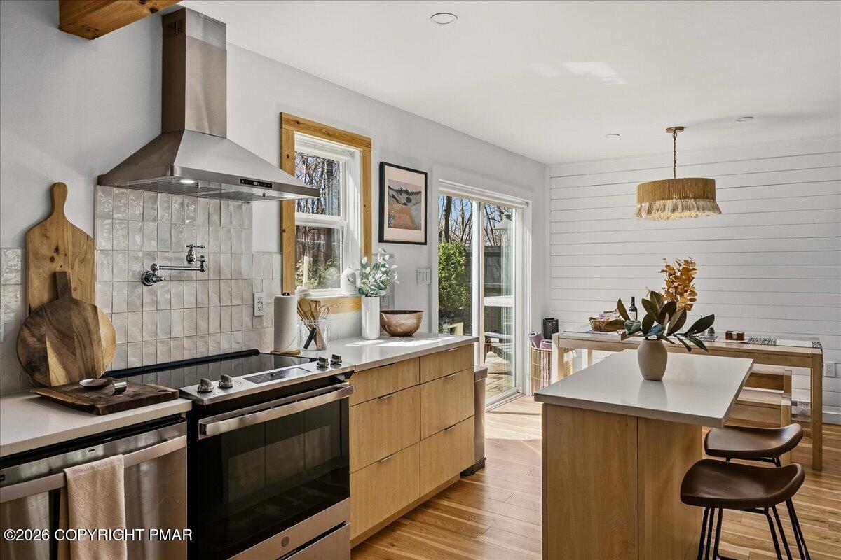 5306 Hummingbird Drive Pocono Summit, PA 18346 - Photo 14 of 32 a kitchen with a stove and a wooden floor