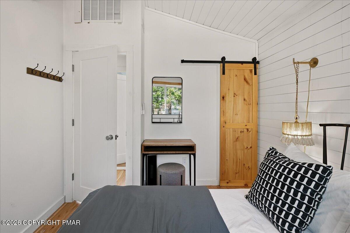 5306 Hummingbird Drive Pocono Summit, PA 18346 - Photo 17 of 32 a view of a hallway with wooden floor and staircase