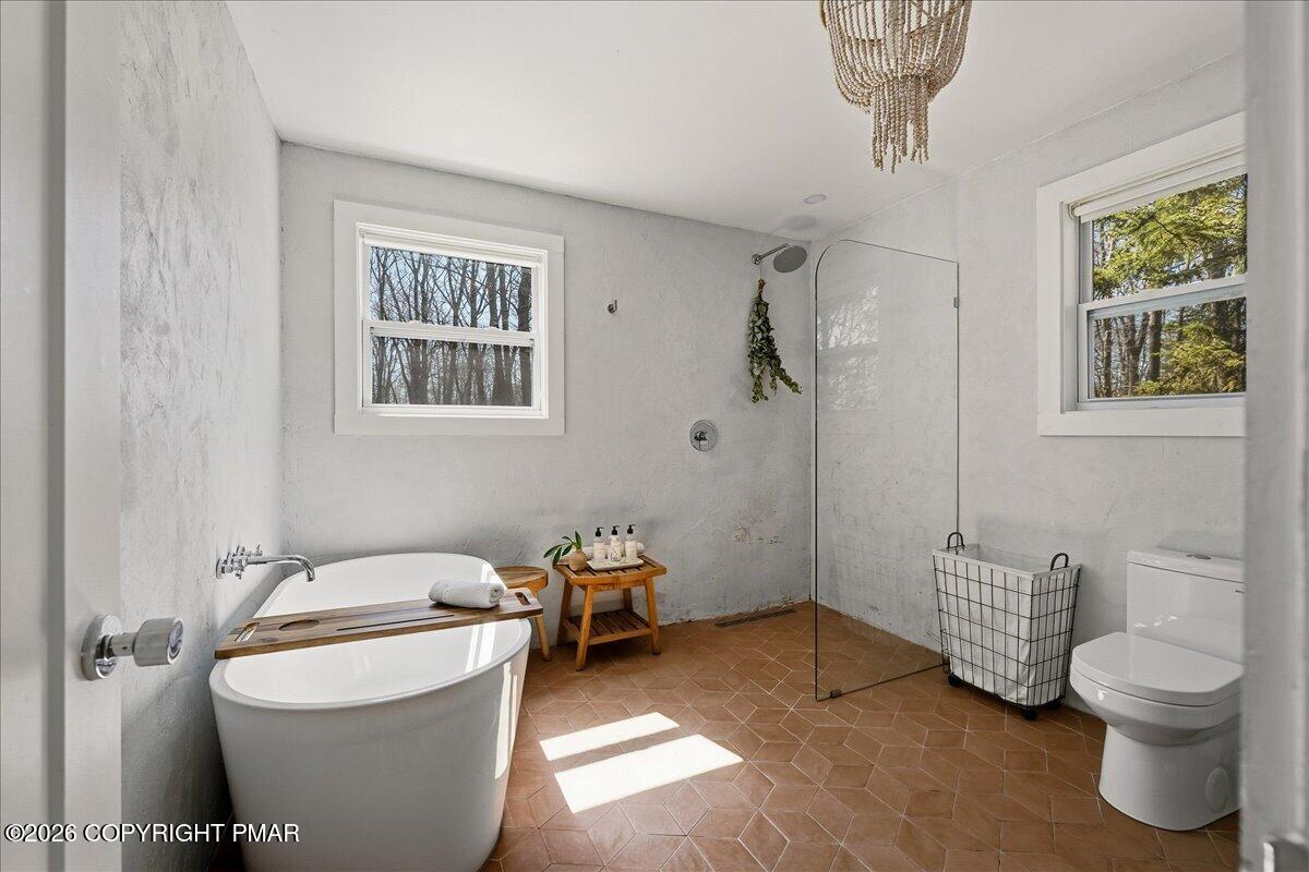 5306 Hummingbird Drive Pocono Summit, PA 18346 - Photo 18 of 32 a bathroom with a toilet sink and shower