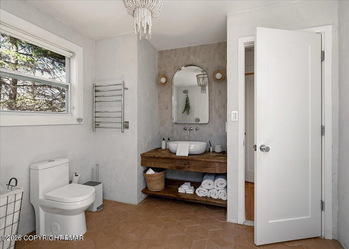 5306 Hummingbird Drive Pocono Summit, PA 18346 - Photo 19 of 32 a bathroom with a toilet sink and mirror