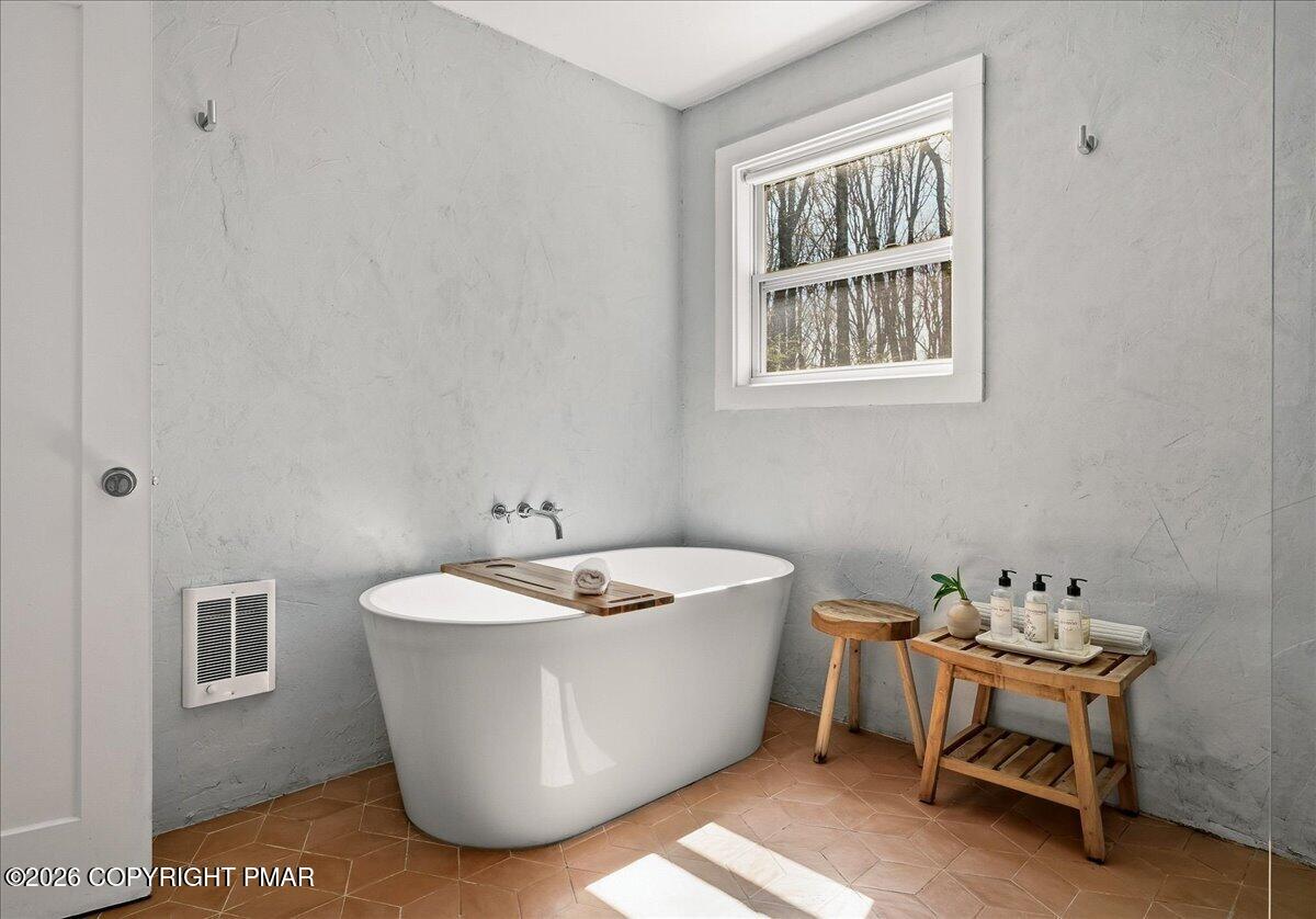 5306 Hummingbird Drive Pocono Summit, PA 18346 - Photo 20 of 32 a spacious bathroom with a bathtub and sink