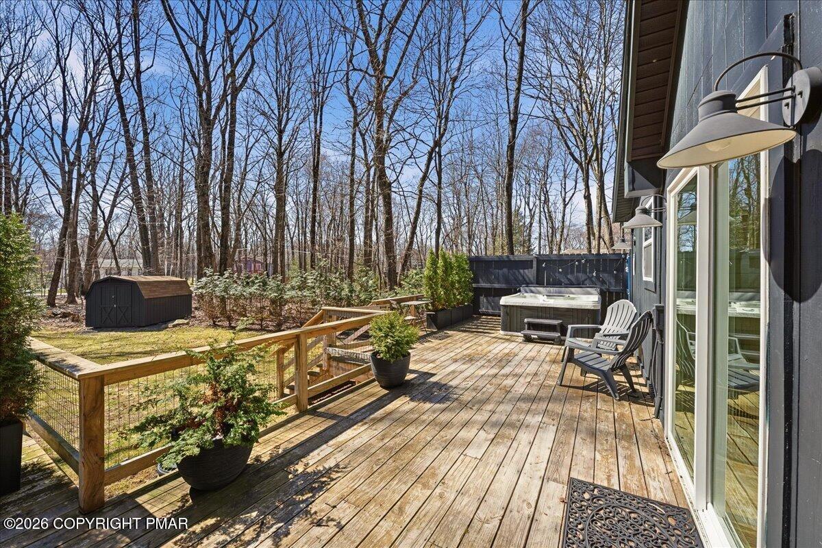 5306 Hummingbird Drive Pocono Summit, PA 18346 - Photo 25 of 32 a view of a patio with table and chairs and wooden floor