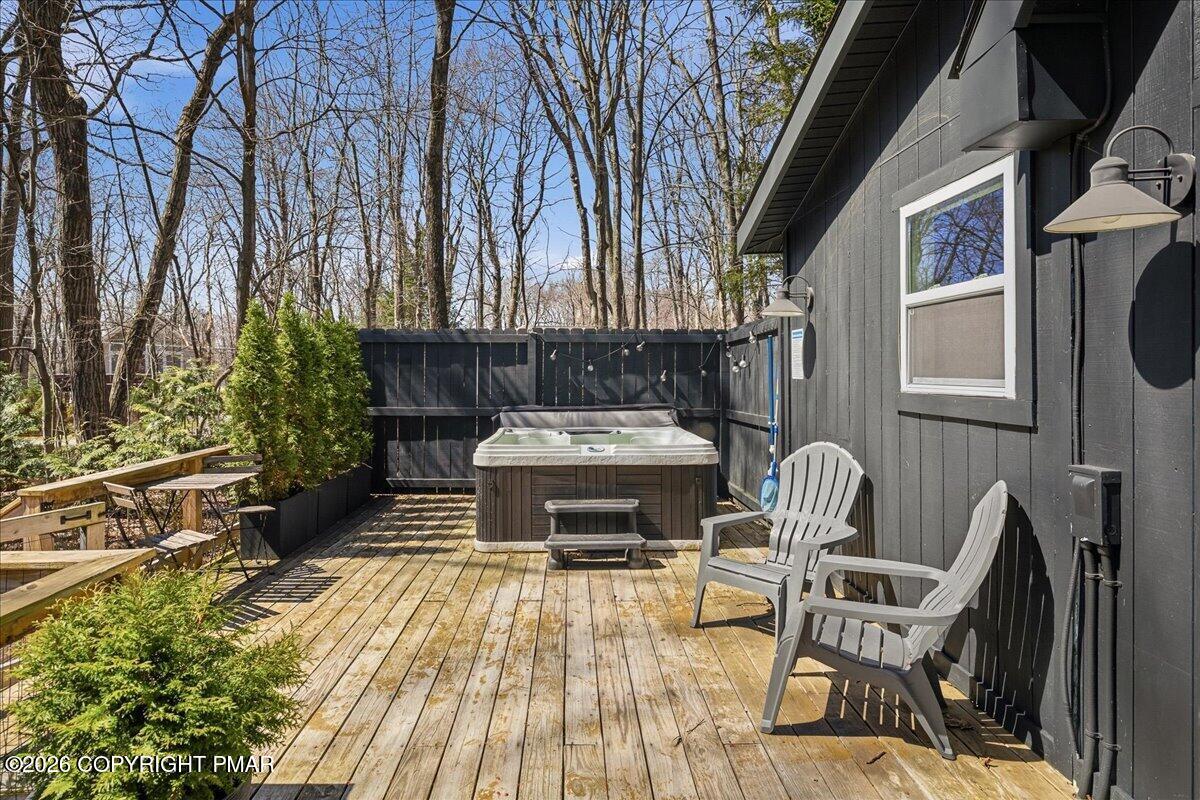 5306 Hummingbird Drive Pocono Summit, PA 18346 - Photo 26 of 32 a table and chairs sitting in front of a house
