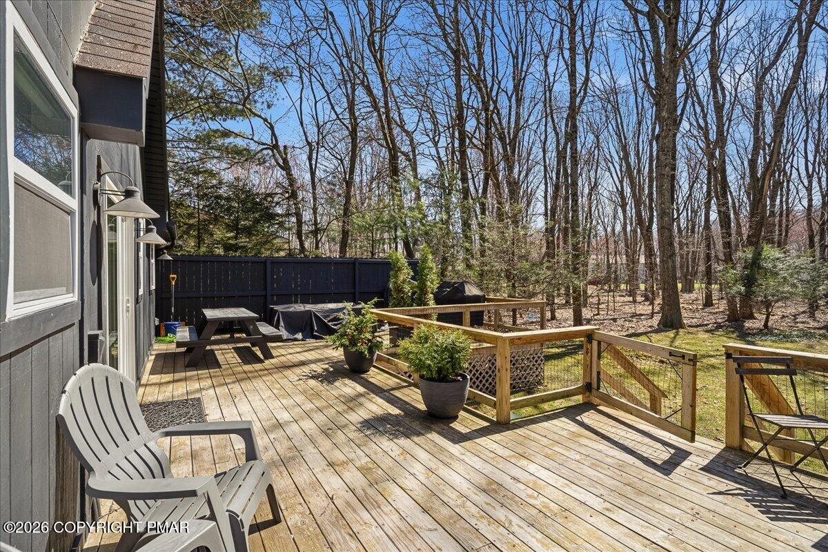 5306 Hummingbird Drive Pocono Summit, PA 18346 - Photo 27 of 32 a view of balcony with chairs and wooden floor