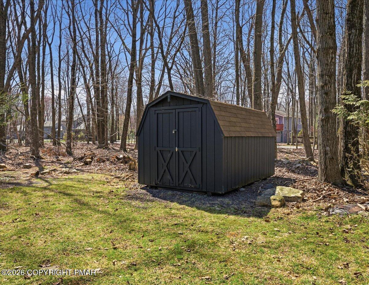 5306 Hummingbird Drive Pocono Summit, PA 18346 - Photo 28 of 32 a view of backyard with large tree and wooden fence