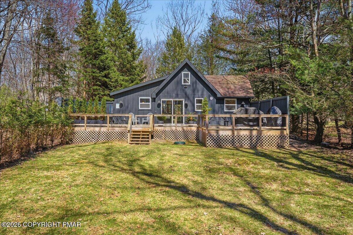 5306 Hummingbird Drive Pocono Summit, PA 18346 - Photo 32 of 32 a white house that has a tree in front of it